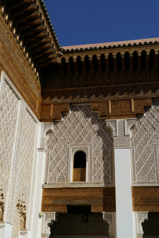 a building with white walls and decorative arches