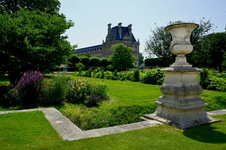 a tall cement statue sits in a grass yard