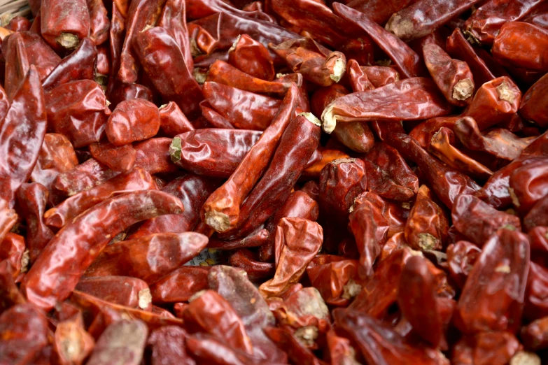 a pile of red chilis on a table