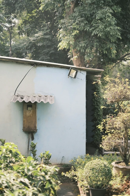 a small house with a flower garden and a door