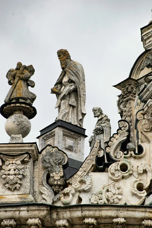 statues are above each other on the roof