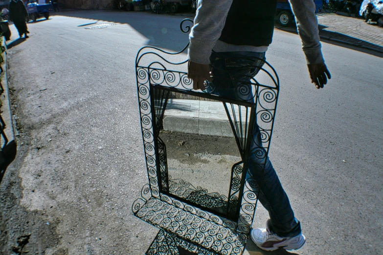 a person walking down a street with a piece of furniture on it