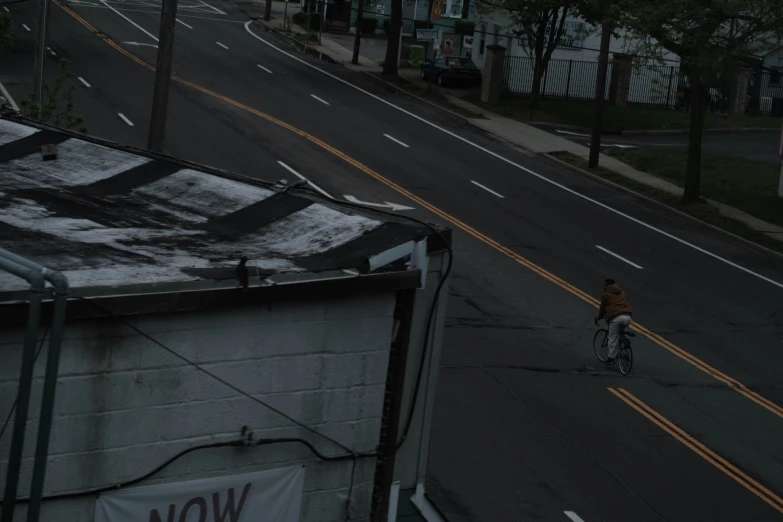 a person riding on a bike down a street