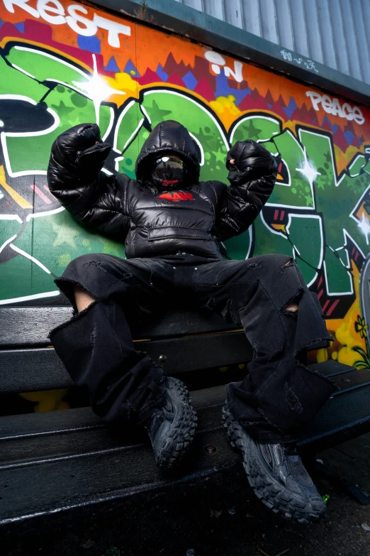 a  sitting on a bench covered in graffiti