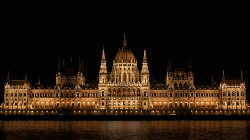 a city at night with lights reflected off the water