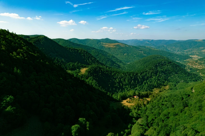 a very scenic view of green mountains with lots of trees