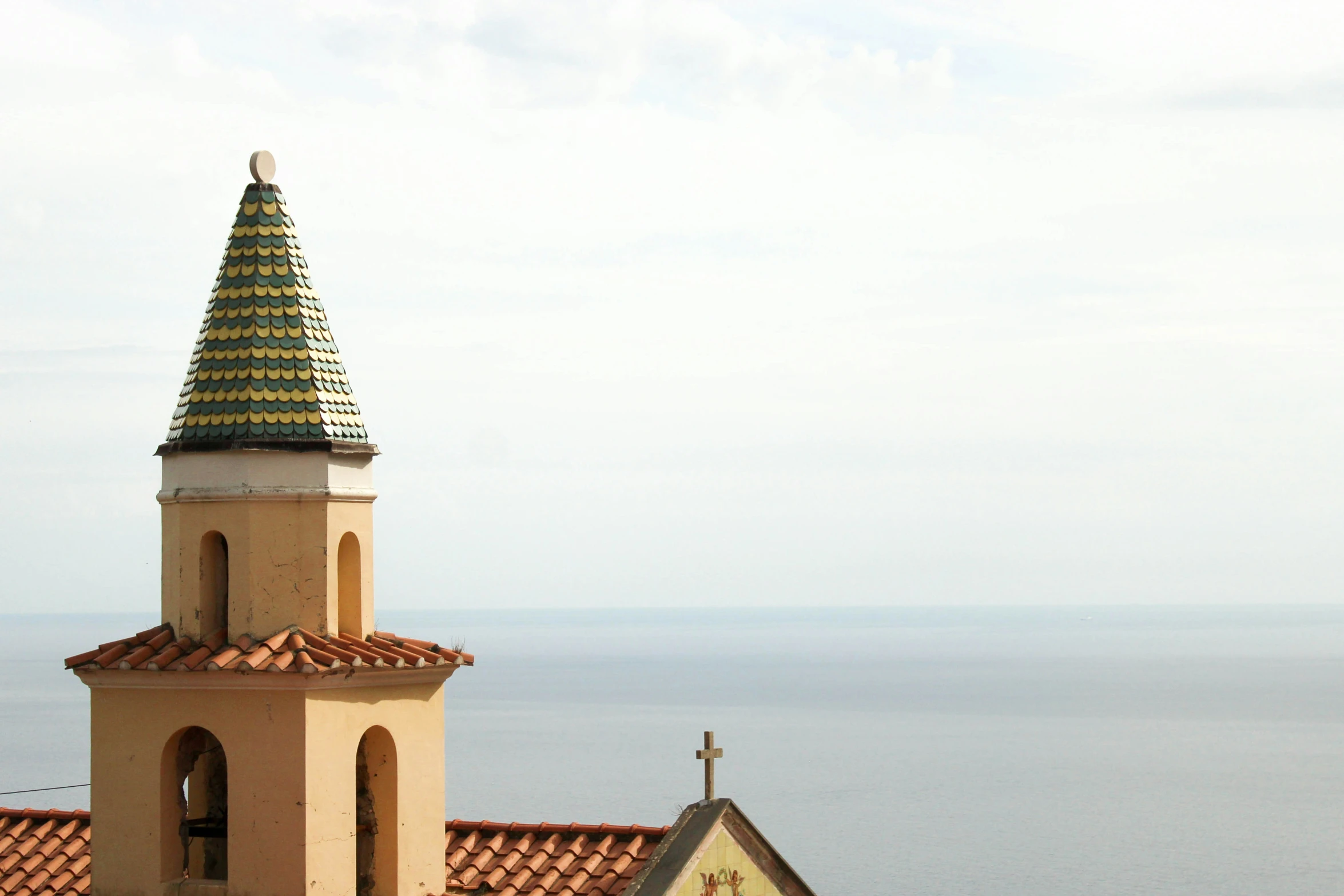 a very tall tower with a cross on top