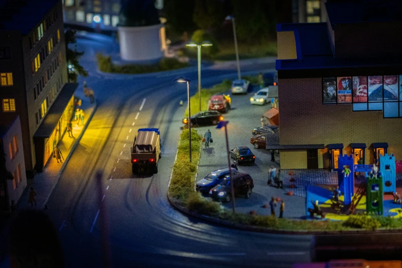 two different colored buses driving down a street at night