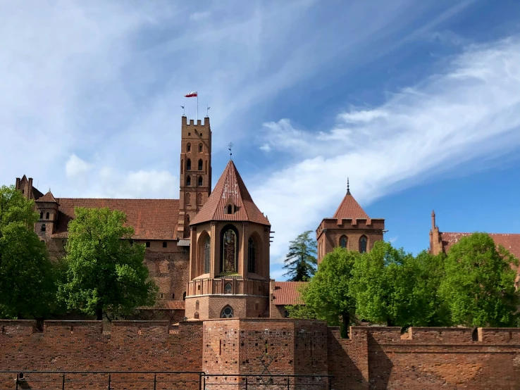 a church spire rises above the surrounding city walls