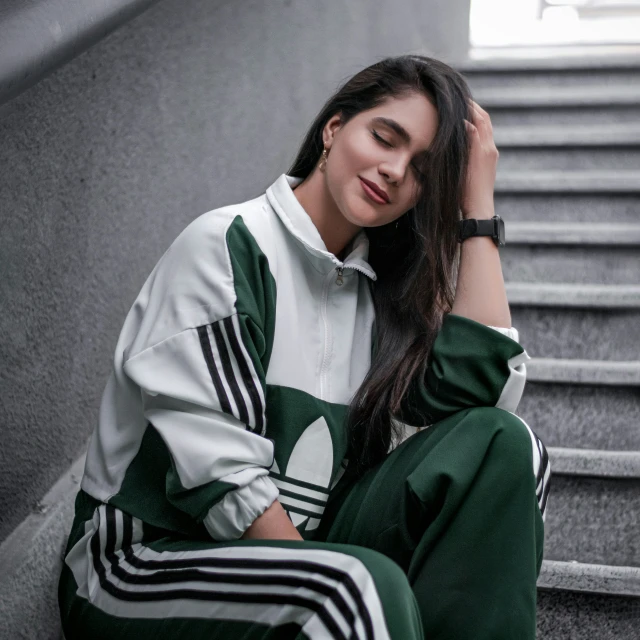 young women wearing green and white striped tracksuits