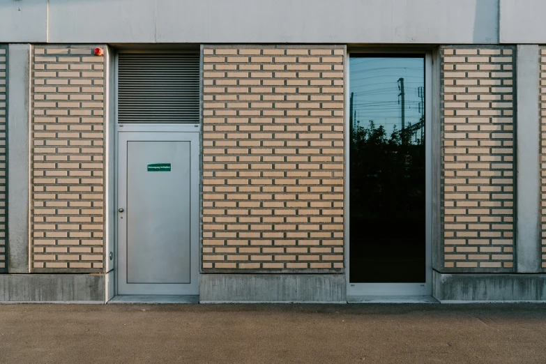 the front view of an industrial building with bricked doors