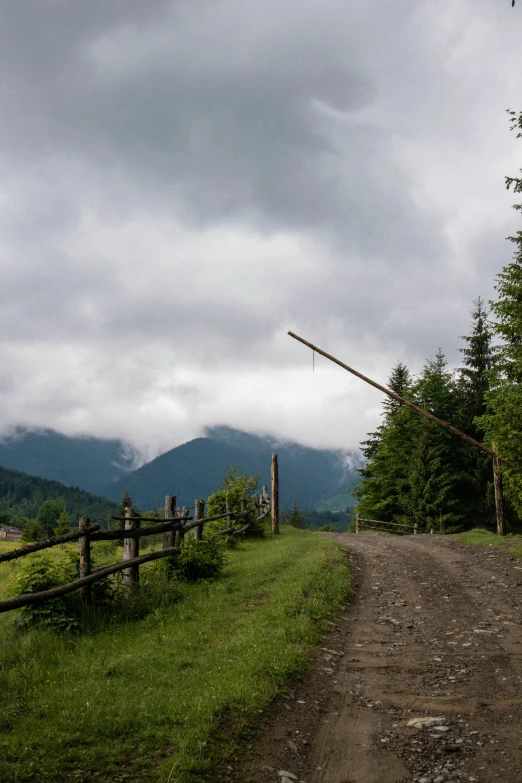 a pathway leads to a fenced in hill top