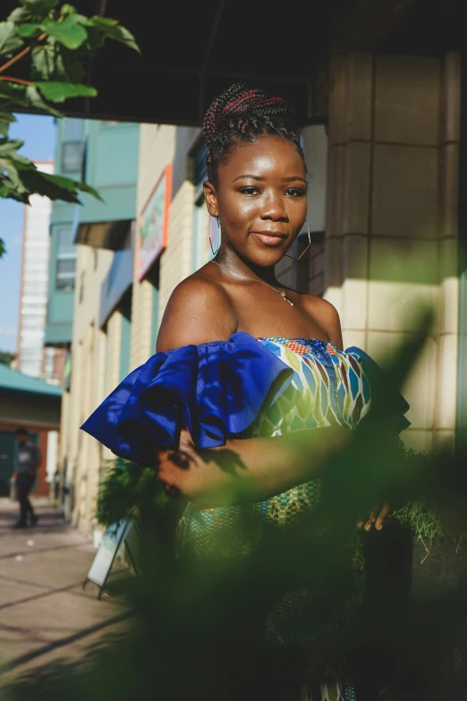 a beautiful woman standing on the sidewalk