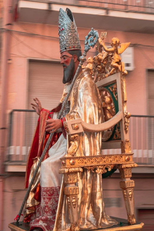 a religious statue of an eastern man dressed in gold