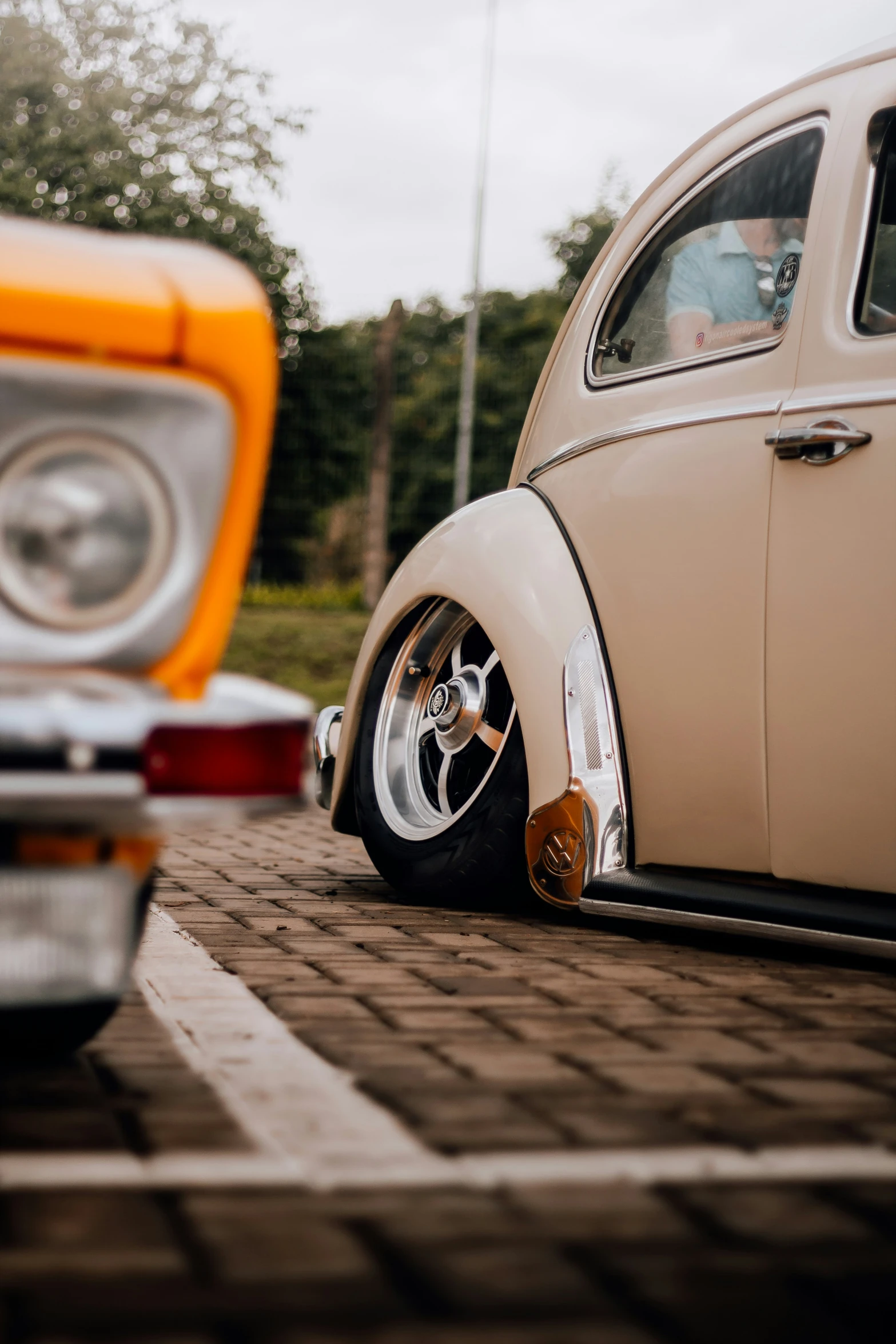 classic cars are parked in a parking lot