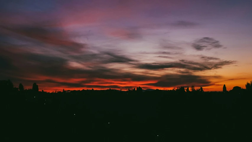 sunset silhouette with clouds on the horizon