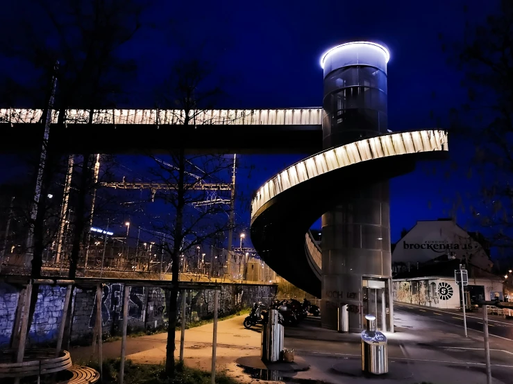 the water tower is next to a modern structure