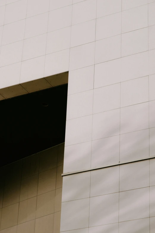 the side of an architectural building with a large window and door