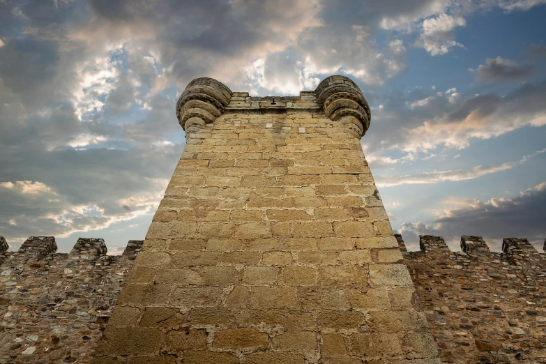 a castle is shown with clouds in the sky