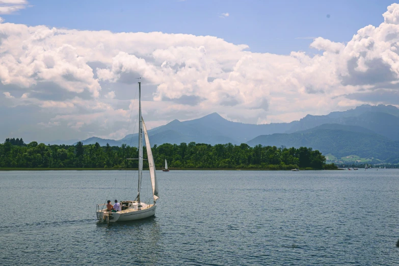 a small sailboat in the middle of a body of water