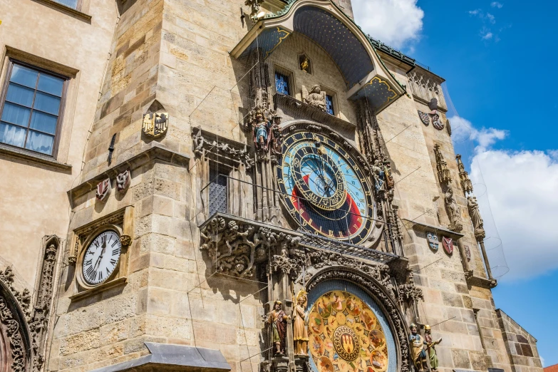 a clock on a stone building with multiple faces