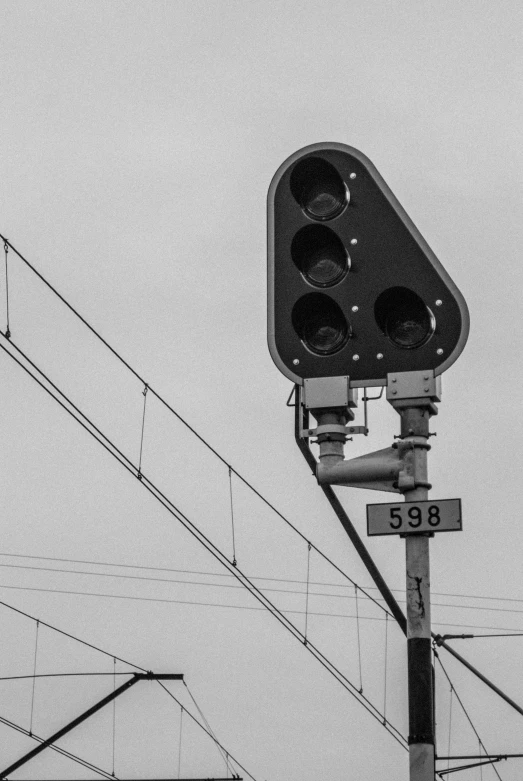 a traffic light on top of a pole near power lines