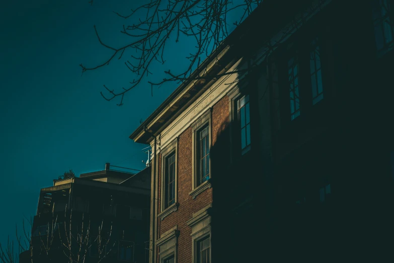 an old red brick building with a clock at the top