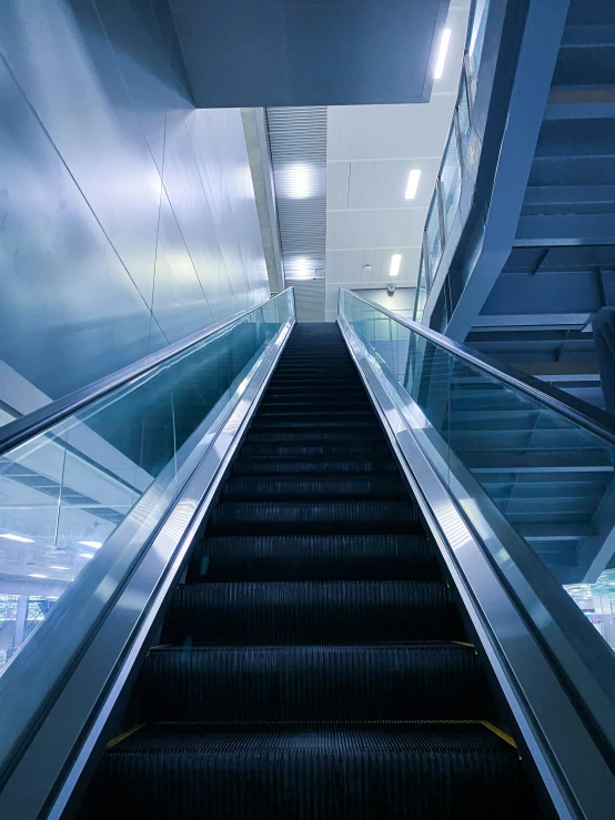 an escalator and stairs in an office building