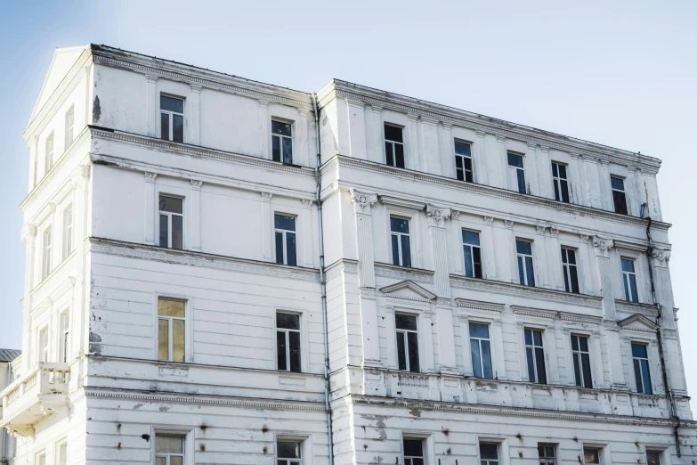 a white building with windows, and a clock