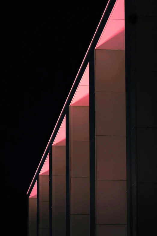 a line of lights lines the side of a building