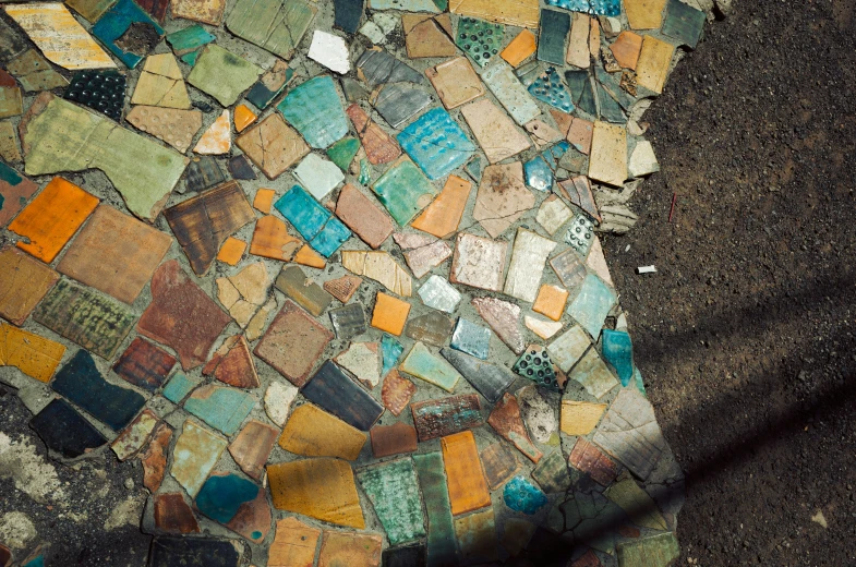 an outdoor bench made of tiles in different colors