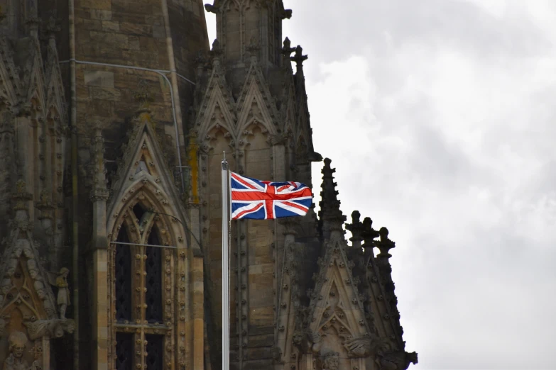 an union jack flag on the corner of a large building