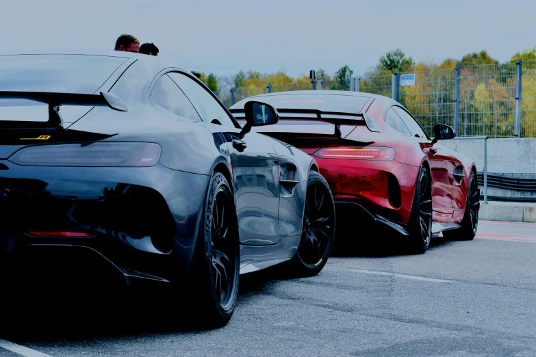 two bmws are parked next to each other on the race track