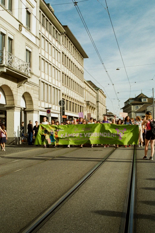 people in the street during a festival next to some buildings