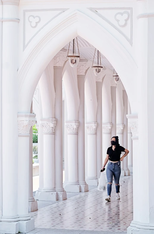 woman with sunglasses running through an archway