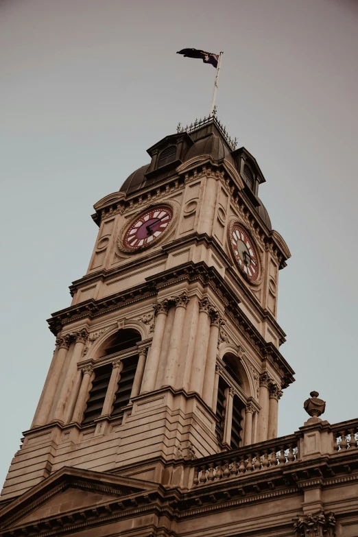 the tall tower on the building has two clocks on it