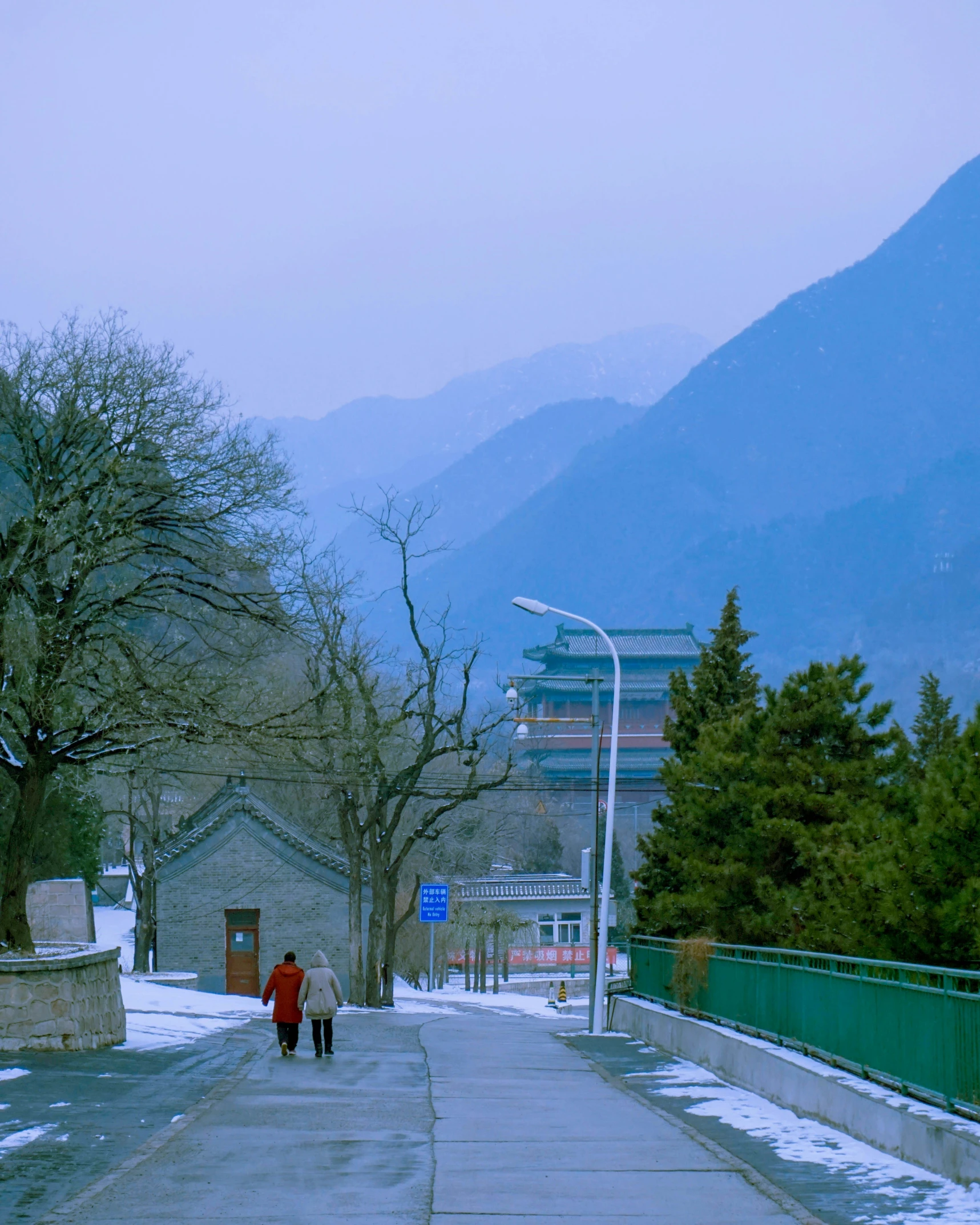 a man and woman are walking down a path