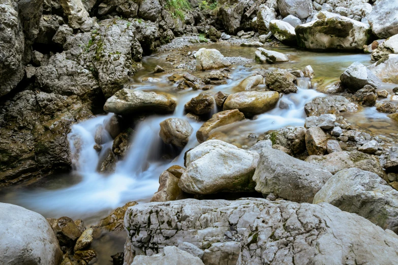 water running down a very nice river with rocks around