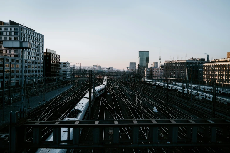 train tracks are next to some buildings in the distance