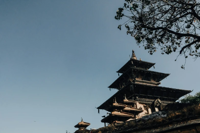 a stone structure stands against the blue sky