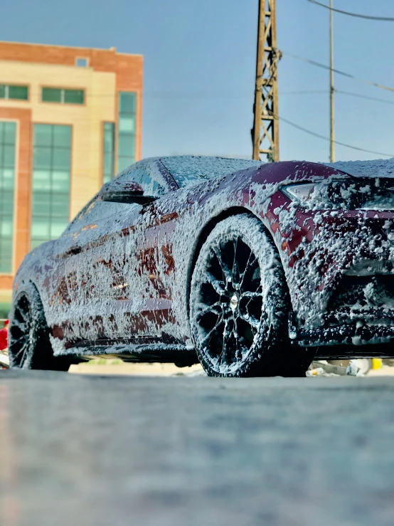 car covered in snow and ice sitting on a street