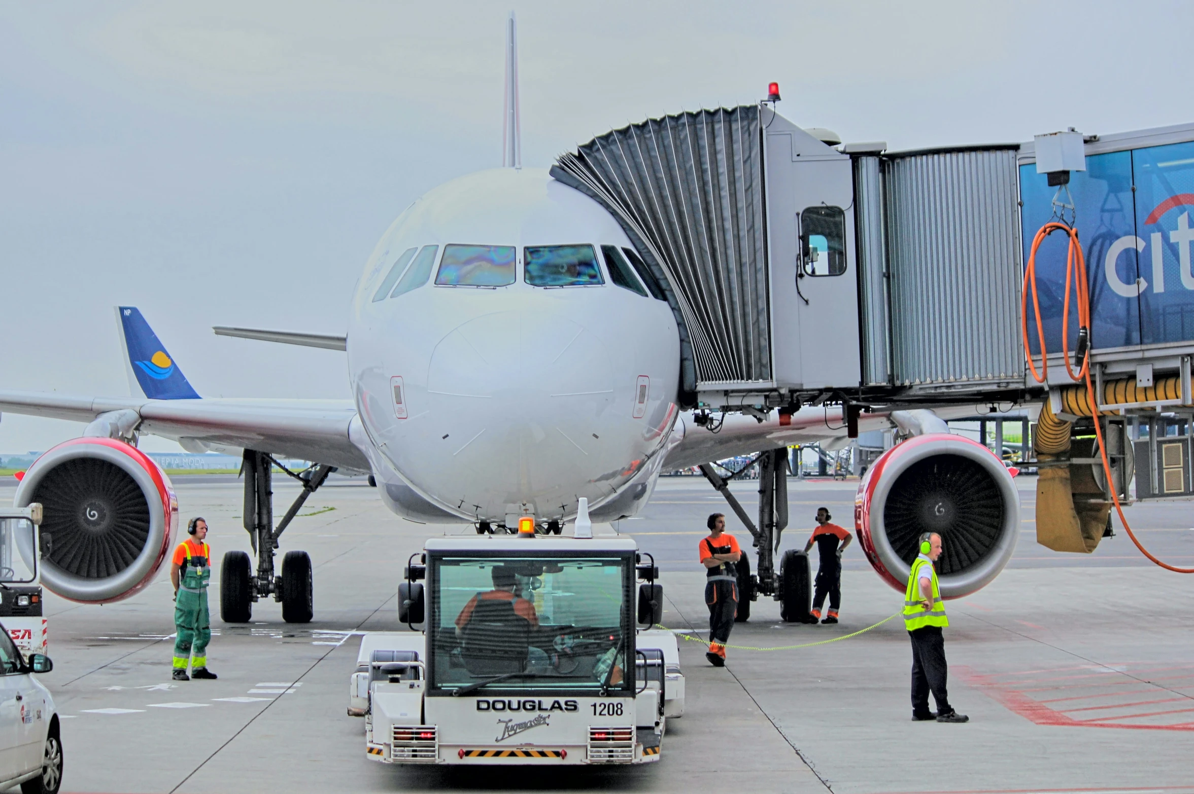 people working around an airplane with airways attached to the wings