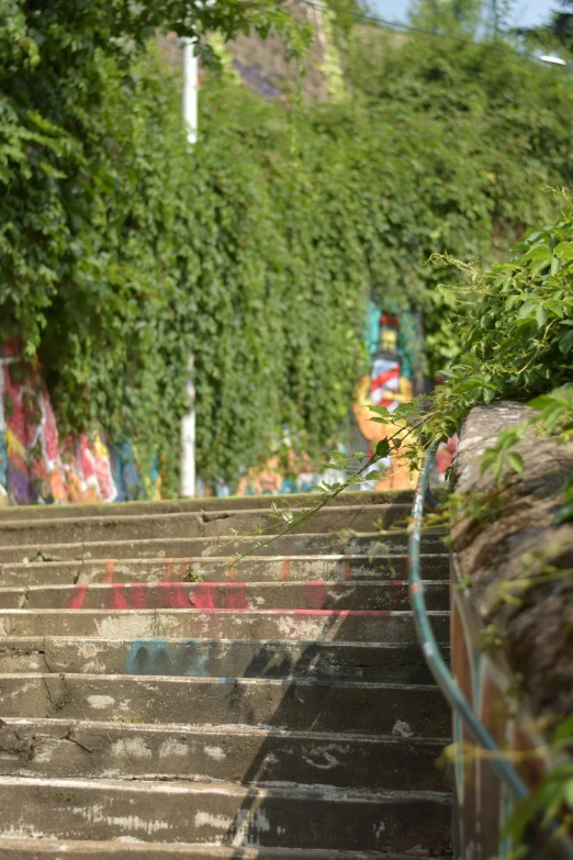 some concrete stairs outside with graffiti on the walls