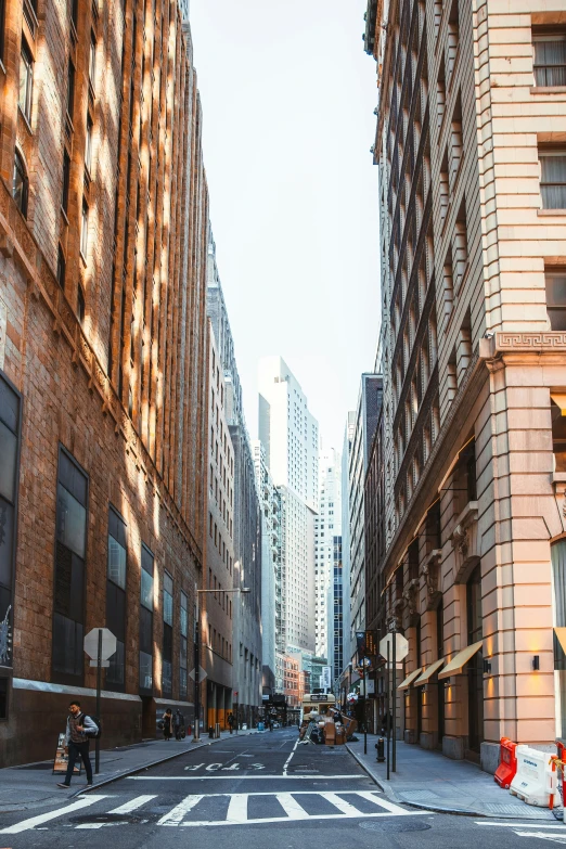 a couple people crossing the street in an urban setting