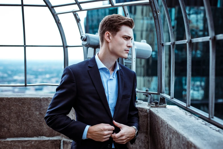 a man standing on the top of a tall building