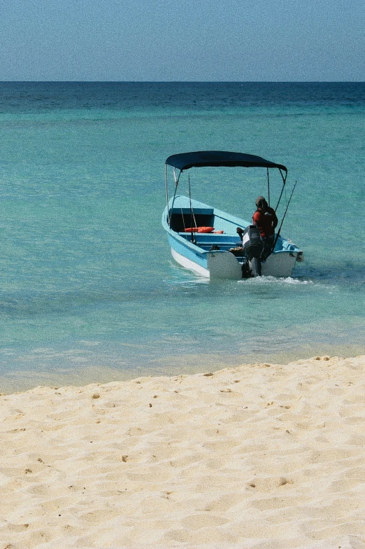 man on water ski near the beach with a small boat