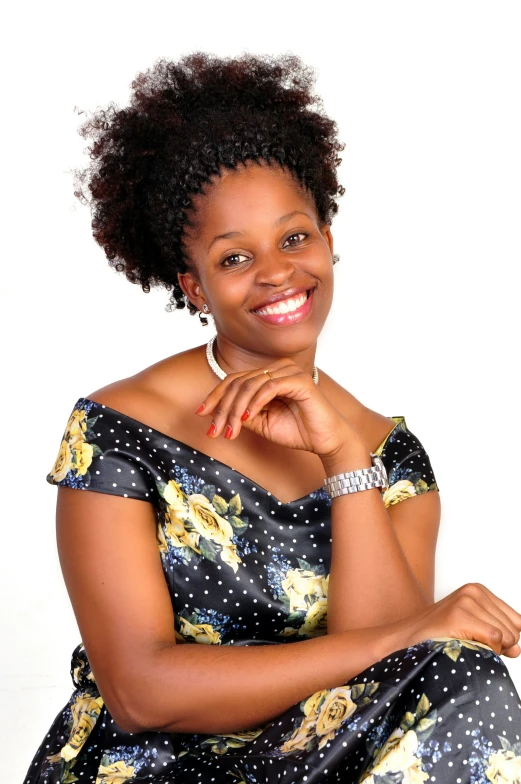 an african american woman sitting in a floral dress