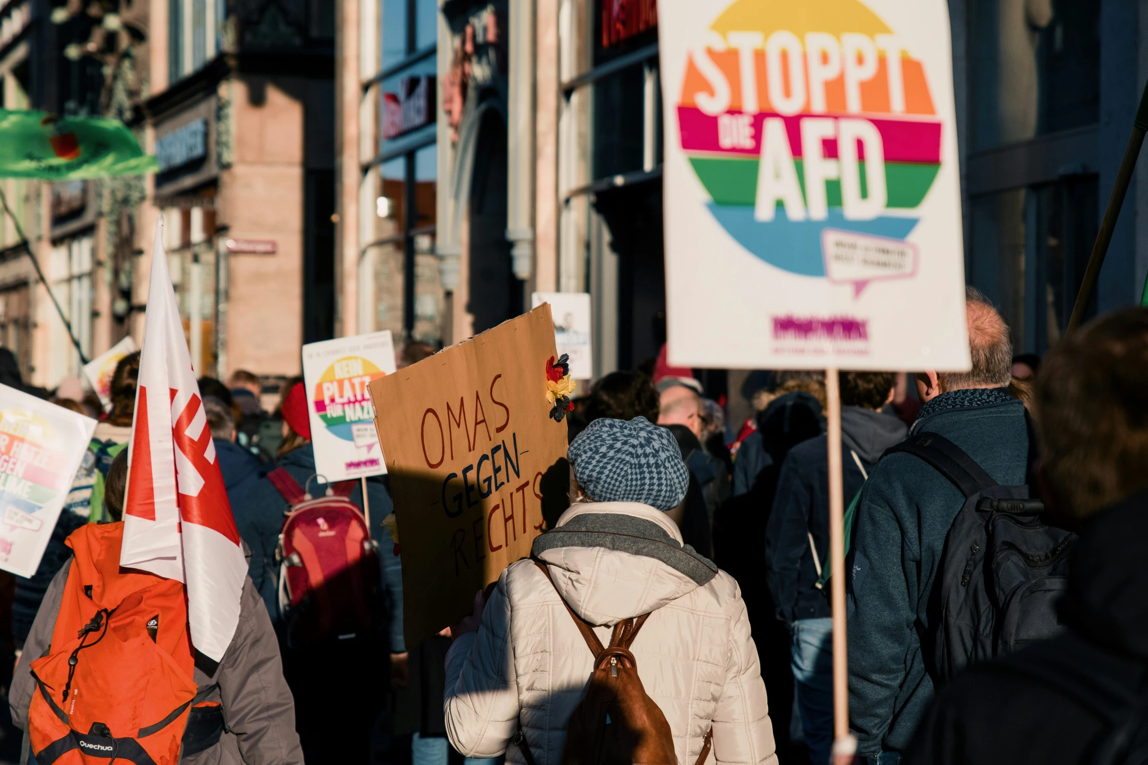 a group of protesters standing in front of a building