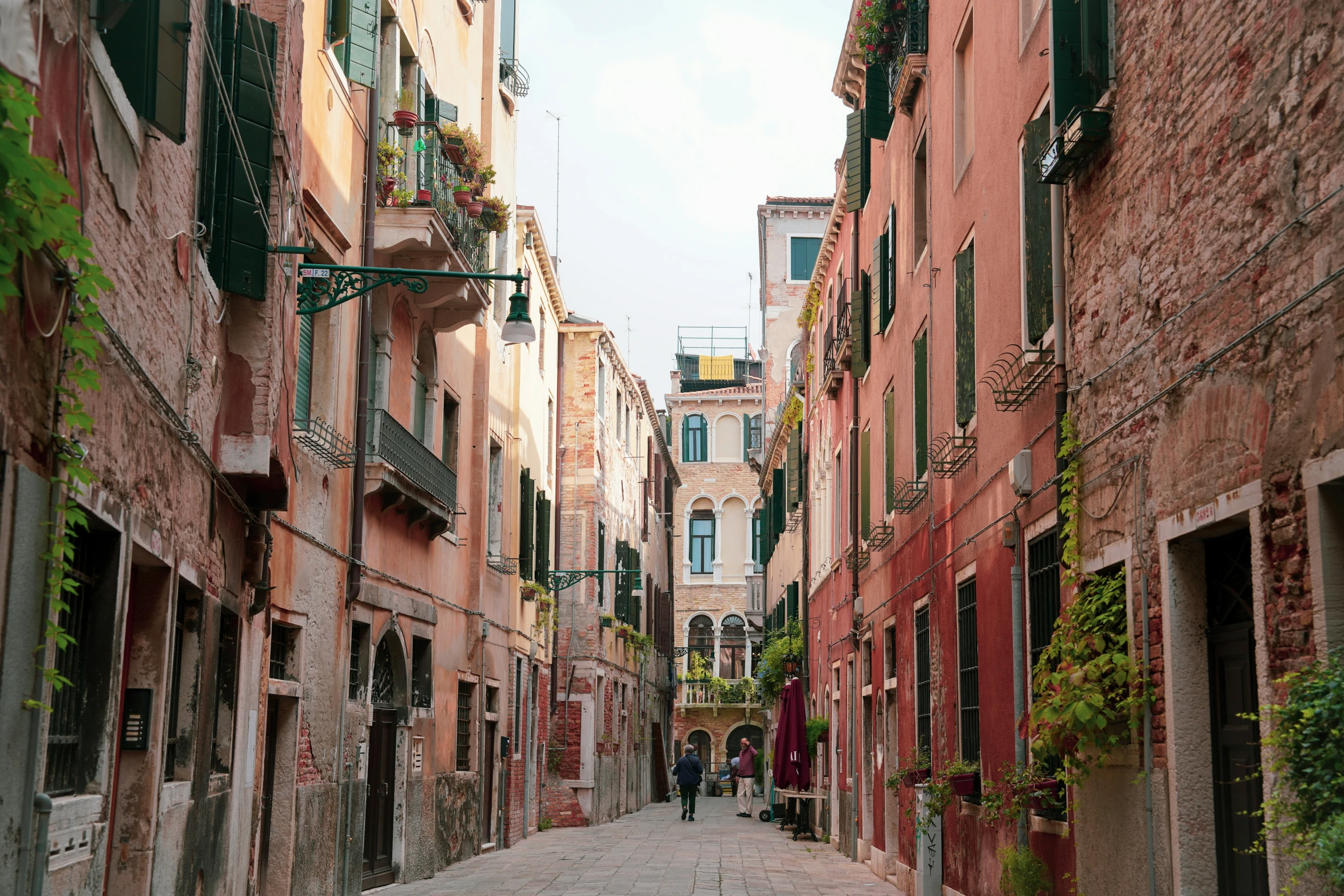 a cobblestone street in an old city with windows and windows