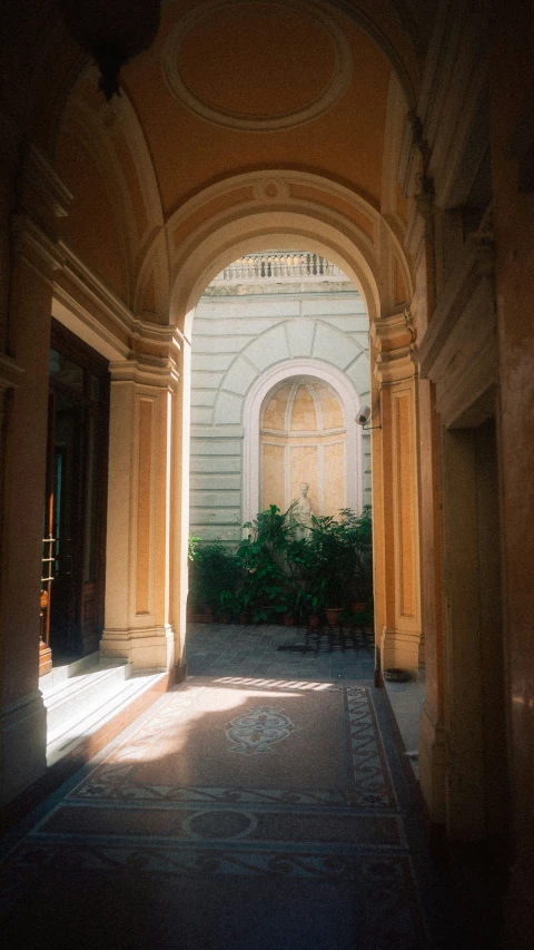 there is a archway that leads into an outside room